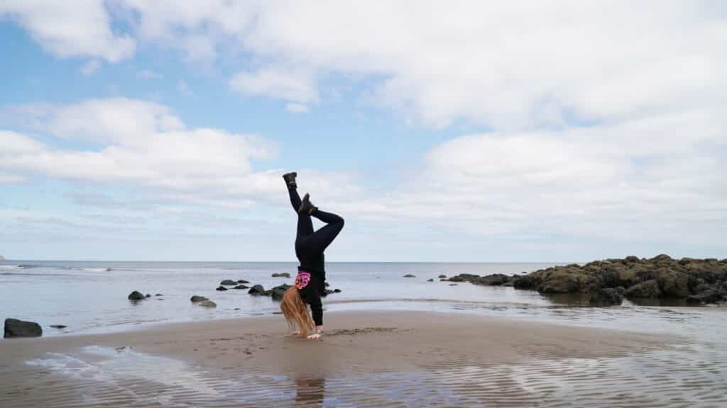 Yoga handstand on a beach